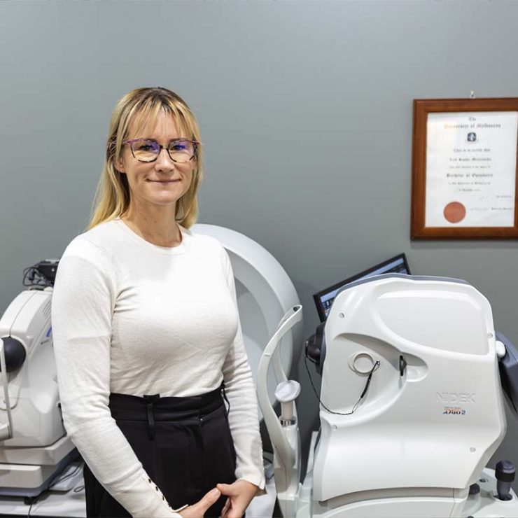 Our blonde lady optometrist wearing white top and glasses.